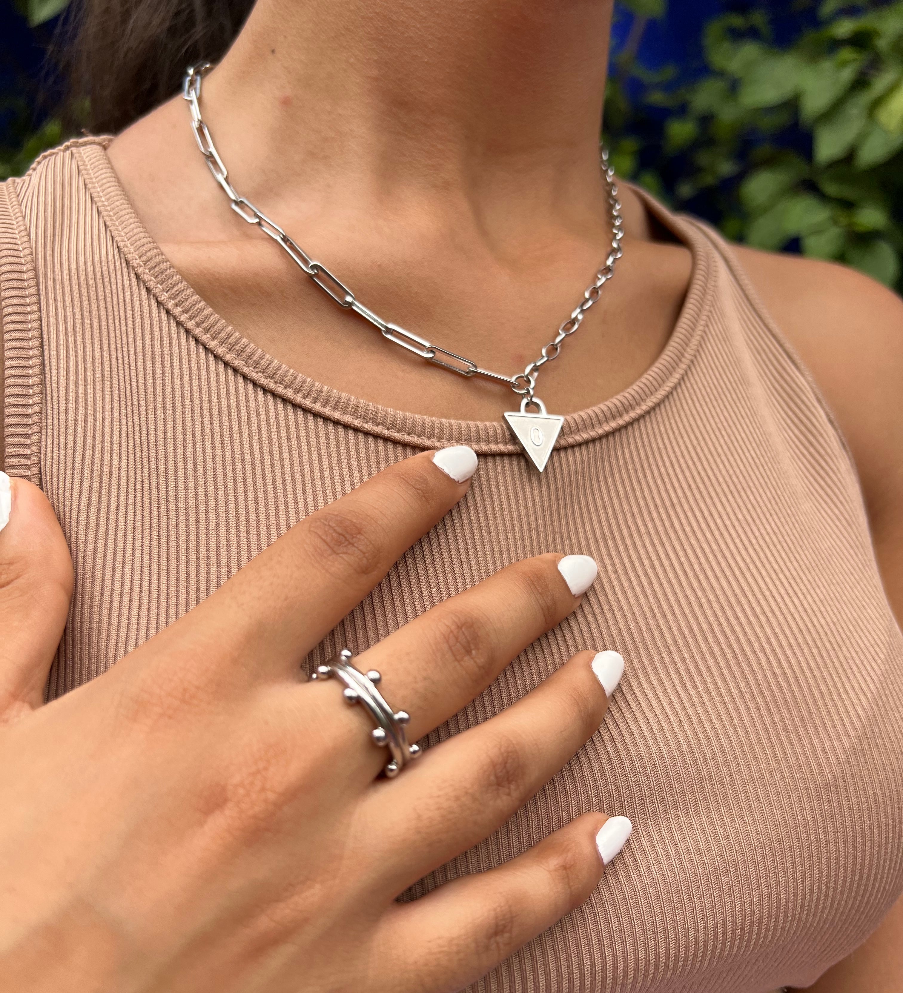 Female wearing padlock necklace in silver , engraved with Affirmation lock in. Stacked with a booble ring in silver