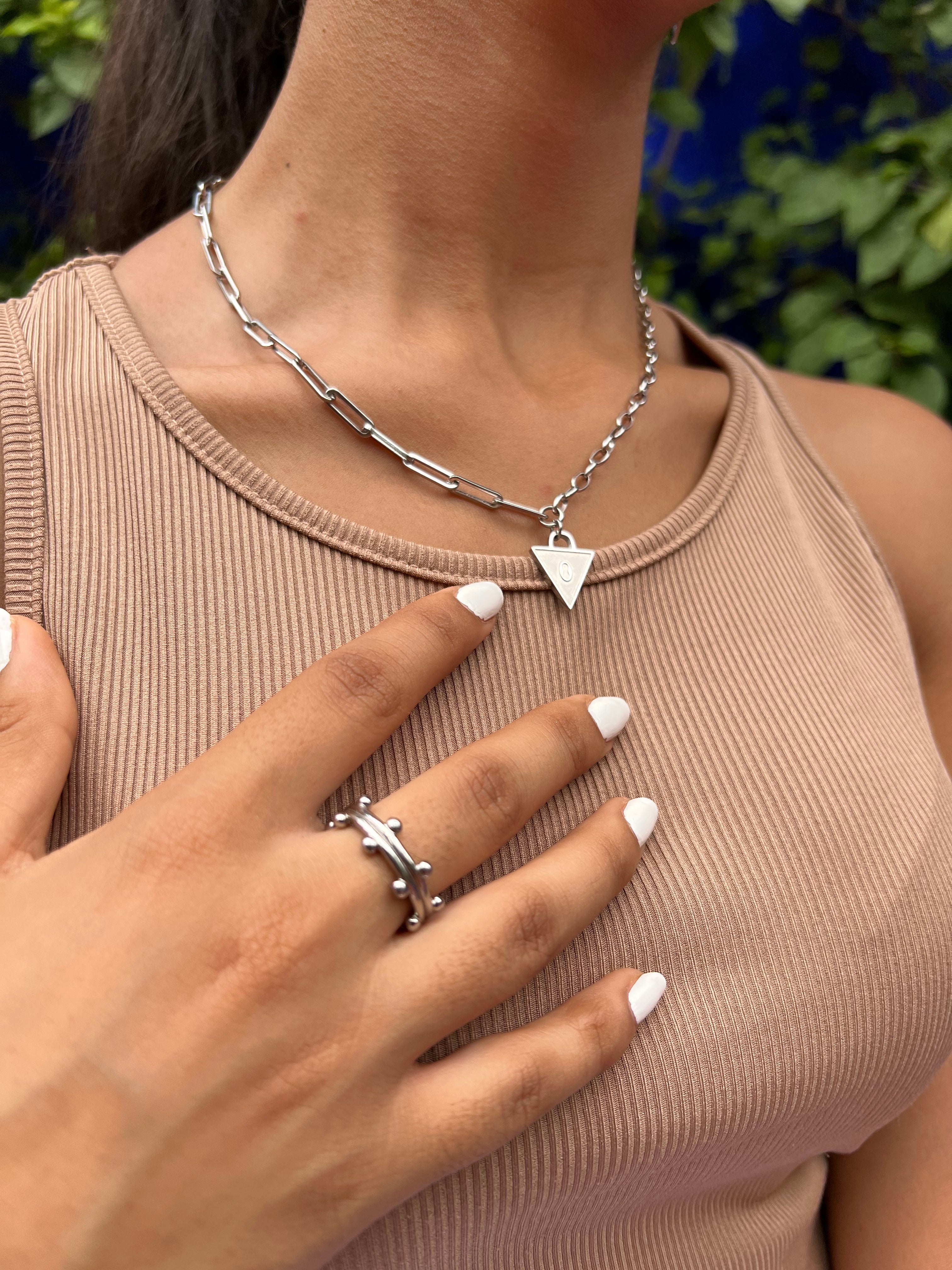 Female wearing padlock necklace in silver , engraved with Affirmation lock in. Stacked with a booble ring in silver